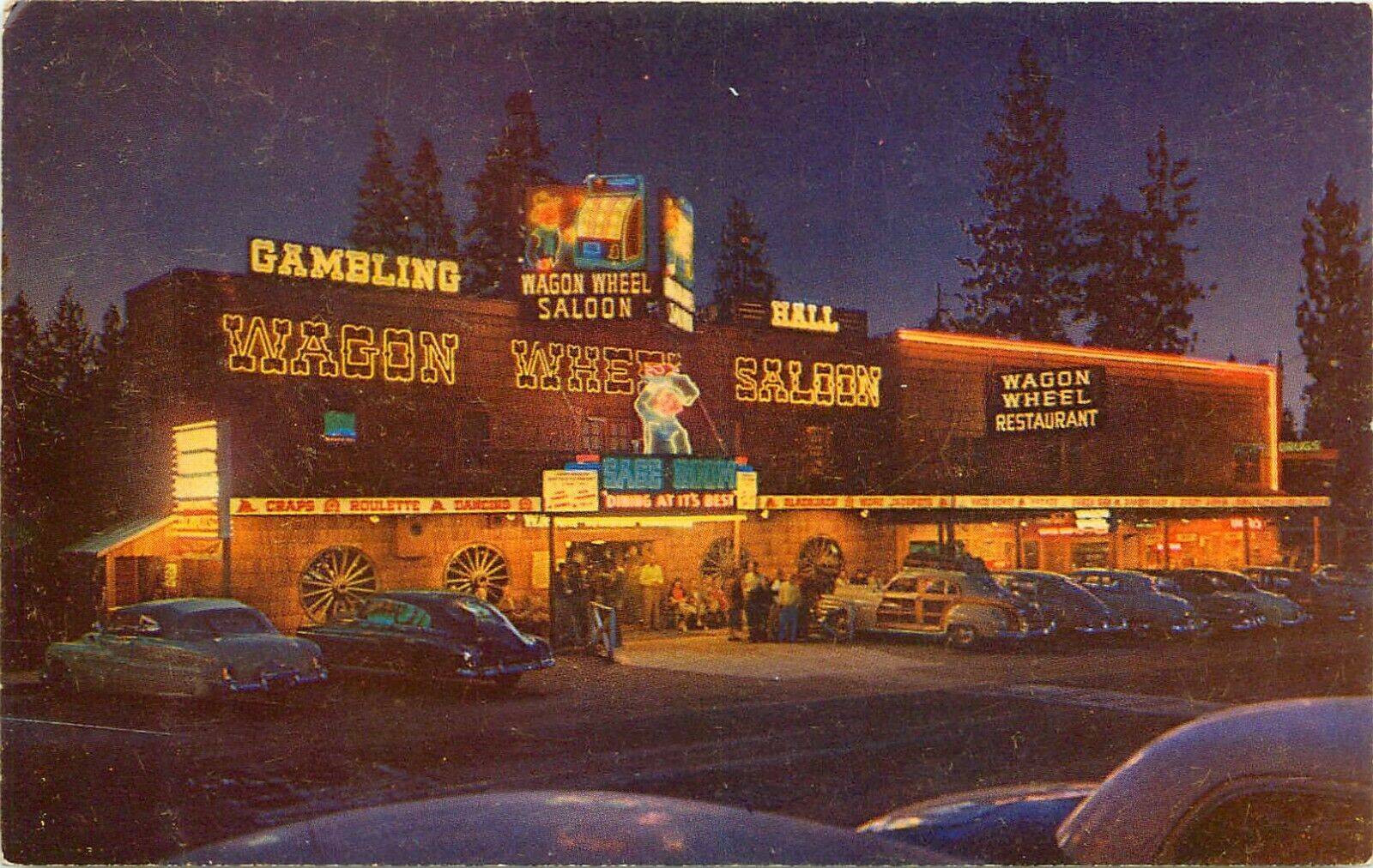 C1950s Wagon Wheels Saloon At Night, State Line, Lake Tahoe, Nevada Postcard